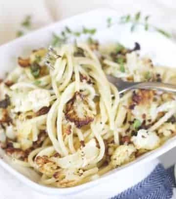 Roasted cauliflower pasta in a bowl garnished with crispy capers