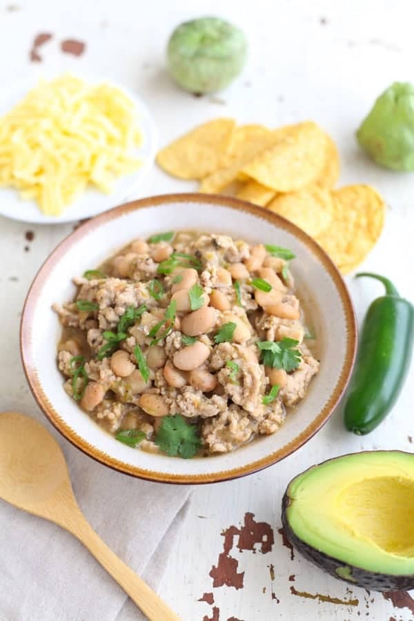 White bean and turkey chili in a bowl garnished with cilantro