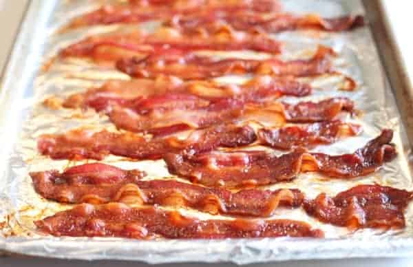 Cooked bacon on a sheet pan covered with foil