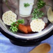 Instant pot filled with ingredients for chicken broth