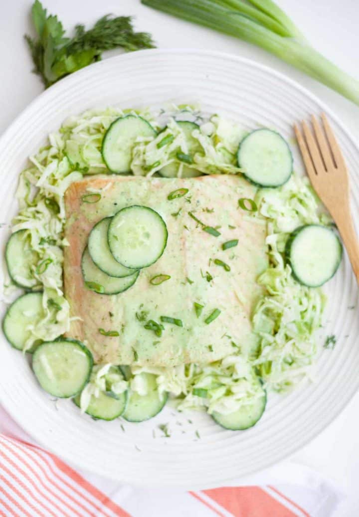 A fillet of buttermilk-dill marinated salmon over a cabbage and cucumber dill salad