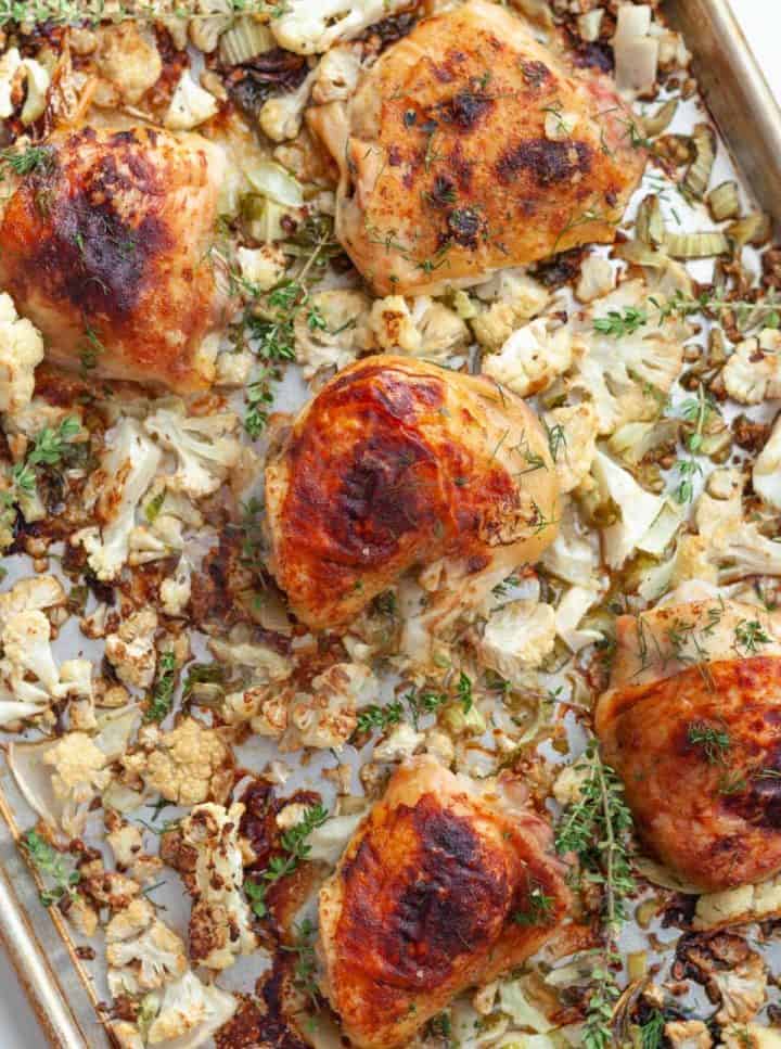 Sheet pan of roasted honey mustard chicken thighs and cauliflower