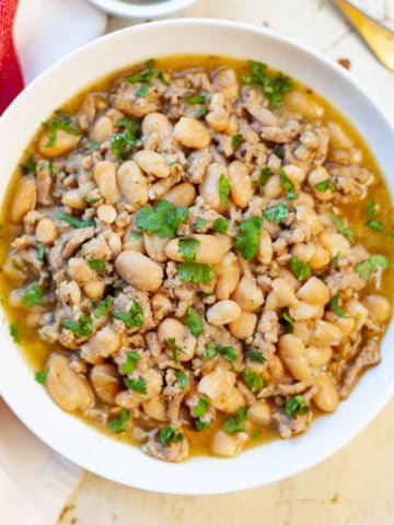 a bowl of Instant Pot White Bean Turkey Chili garnished with cilantro