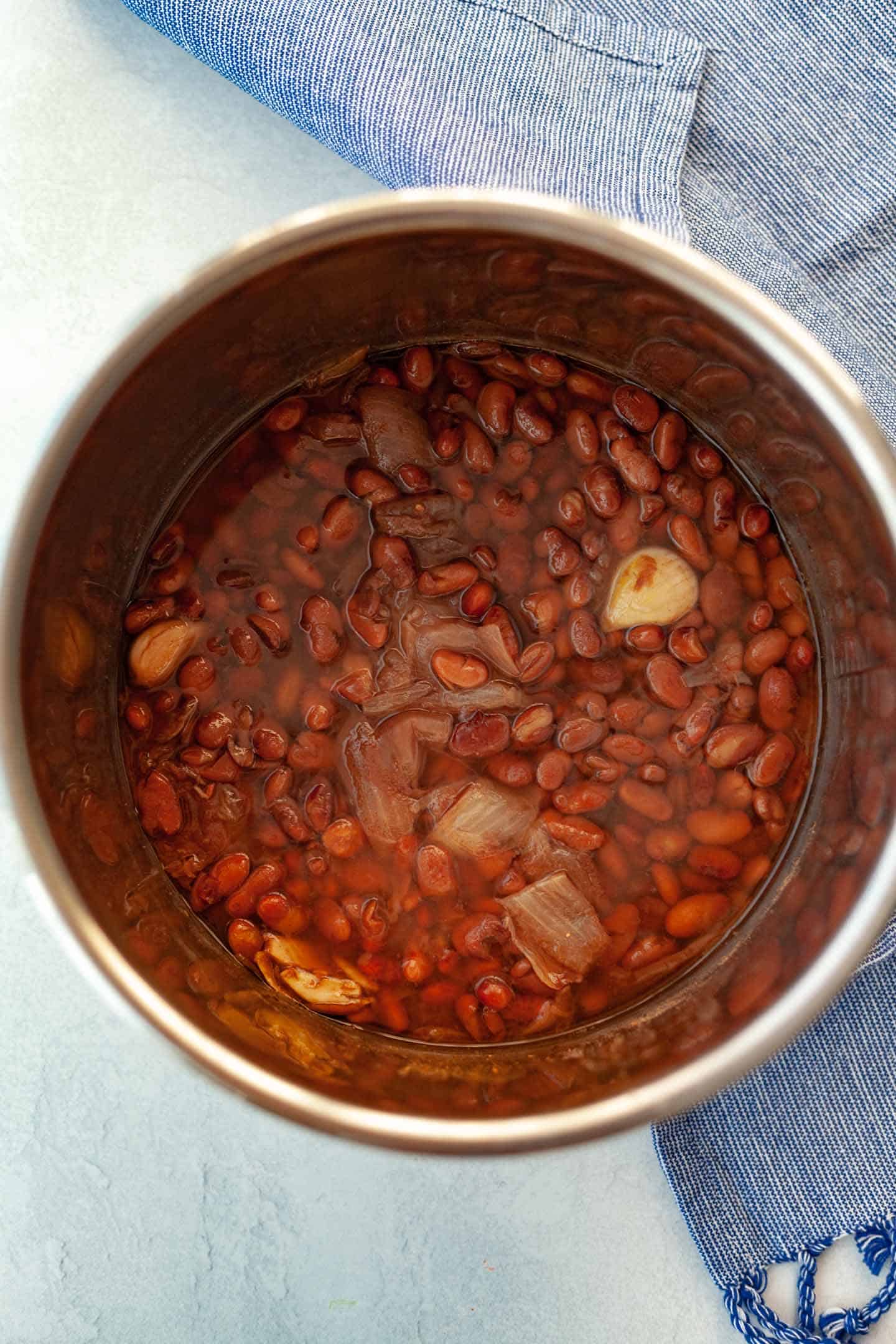 Cooke pinto beans in an Instant Pot with garlic and onion