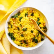 Bowl with yellow turmeric coconut rice, kale and chickpeas