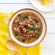 Bowl of 15 bean soup with carrots and spinach