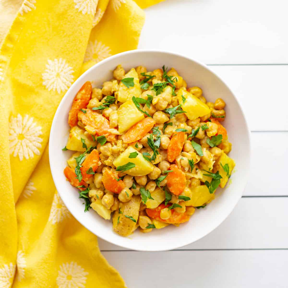 bowl with chickpeas, carrots and potatoes roasted in turmeric and coconut milk