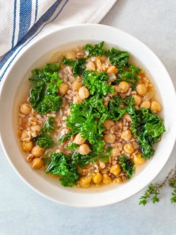 bowl of farro, chickpea and kale soup with lemon-ginger broth