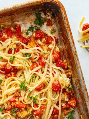 linguine in a pan with tomatoes and cheese