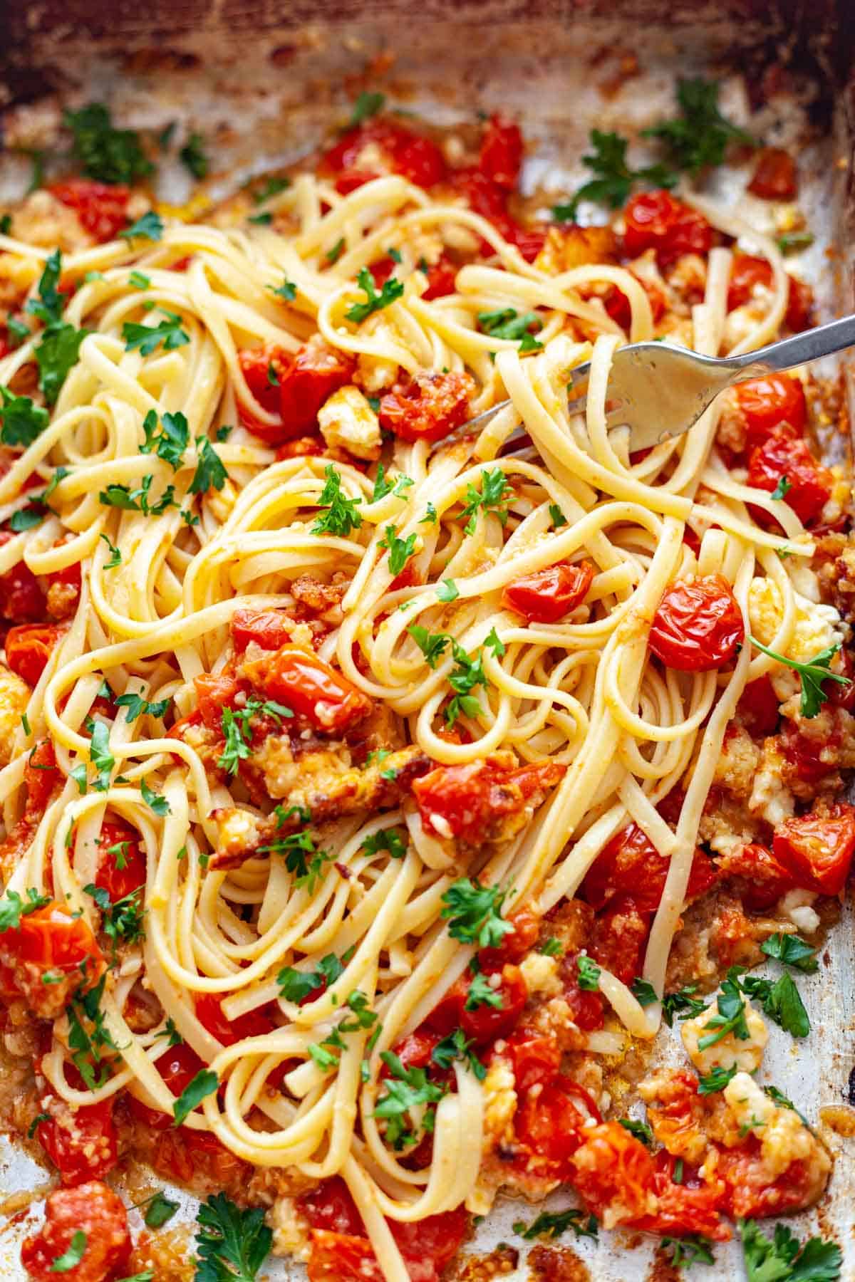 linguine in a pan with tomatoes and cheese