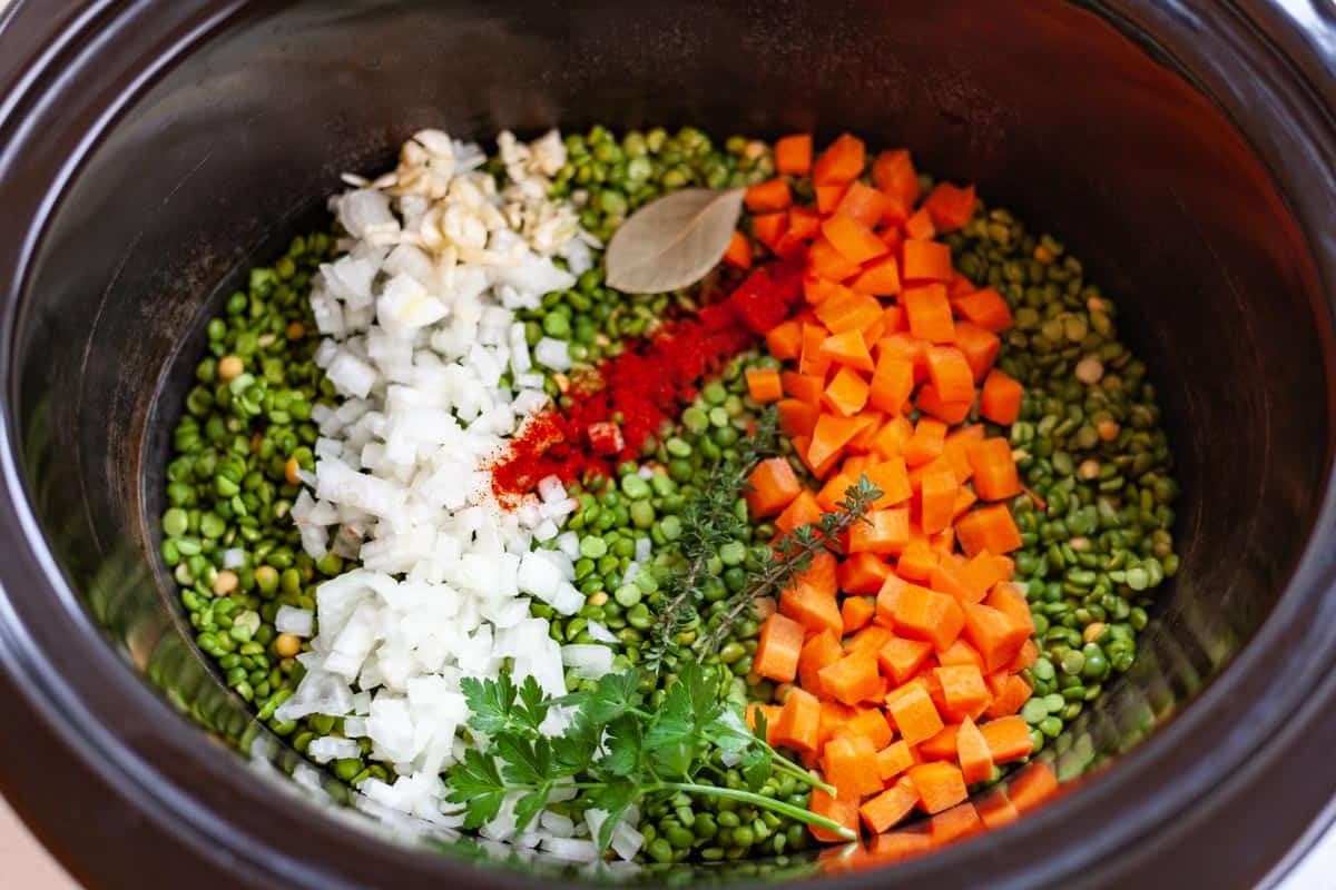 crockpot filled with split pea soup ingredients