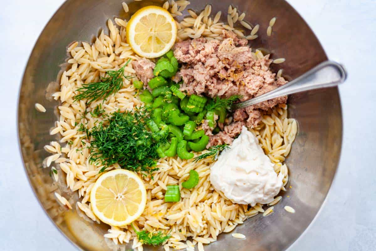 ingredients for tuna pasta salad: orzo, canned tuna, lemon, dill, celery and mayo