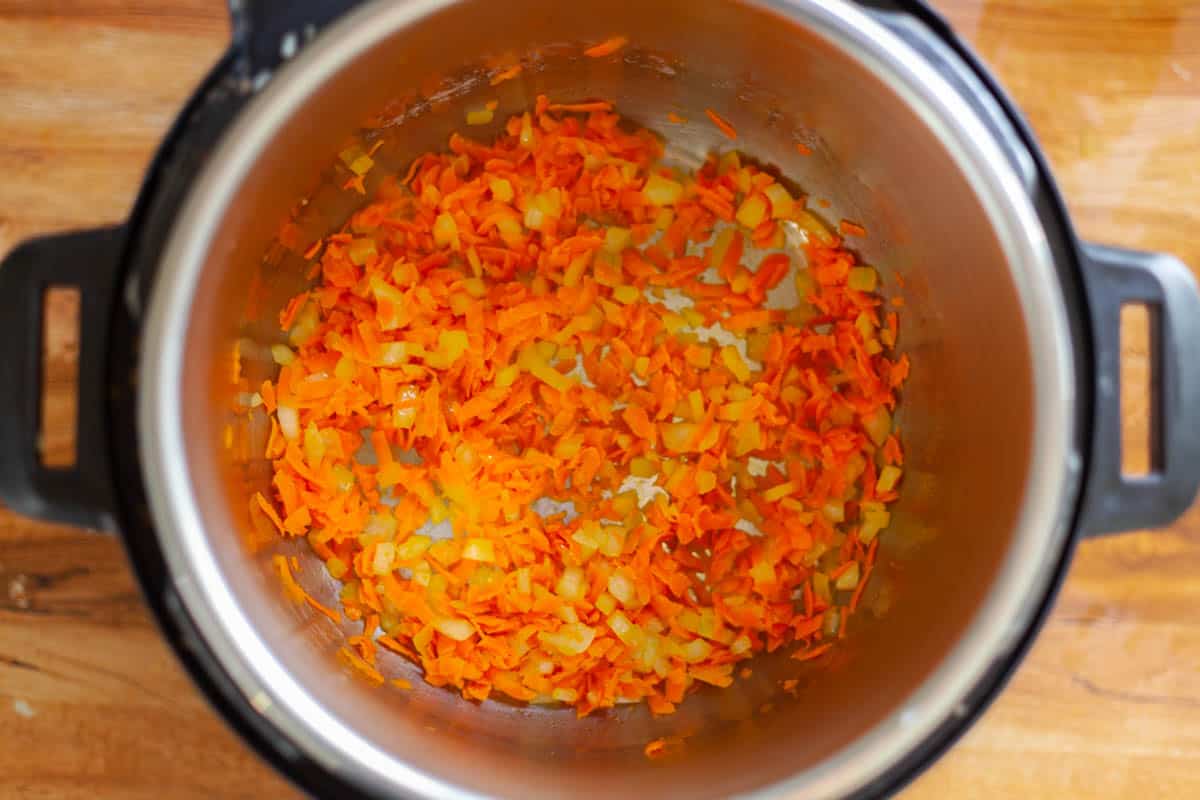 shredded carrot and onion in a pressure cooker