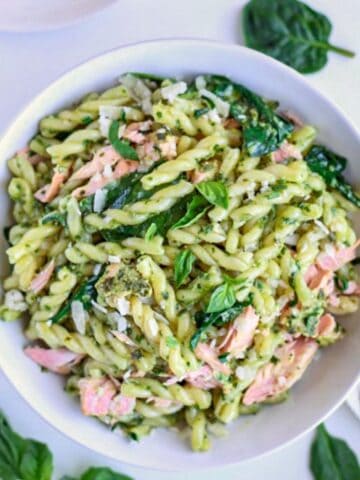 a bowl of gemelli pasta with pesto and salmon