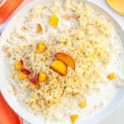 bowl of millet porridge with milk, peaches and cinnamon