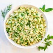 bowl of macaroni salad with chicken and herbs