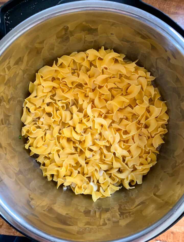 uncooked egg noodles in a pot