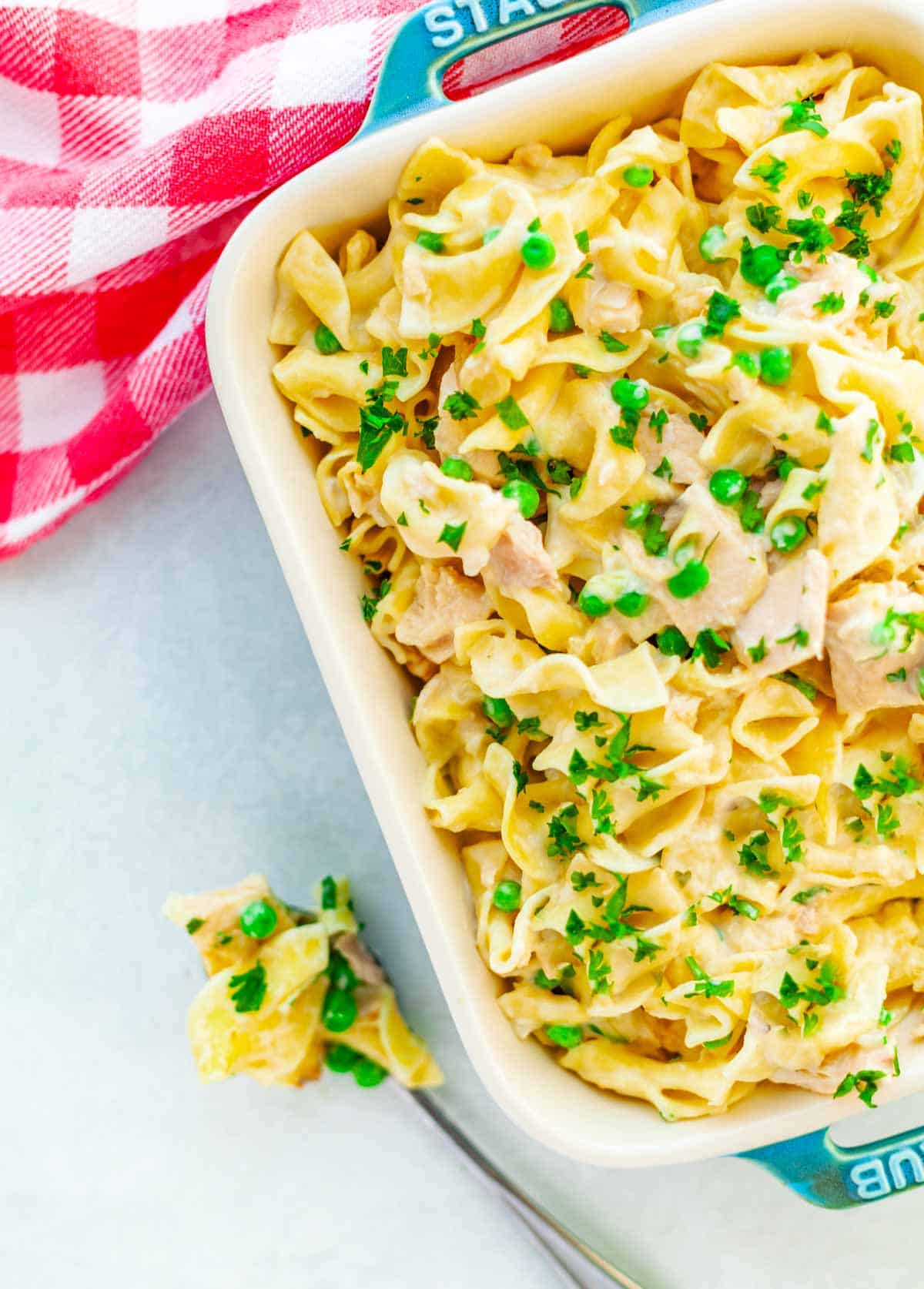 baking dish filled with tuna casserole with egg noodles and peas