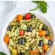 a bowl of spinach pesto pasta salad