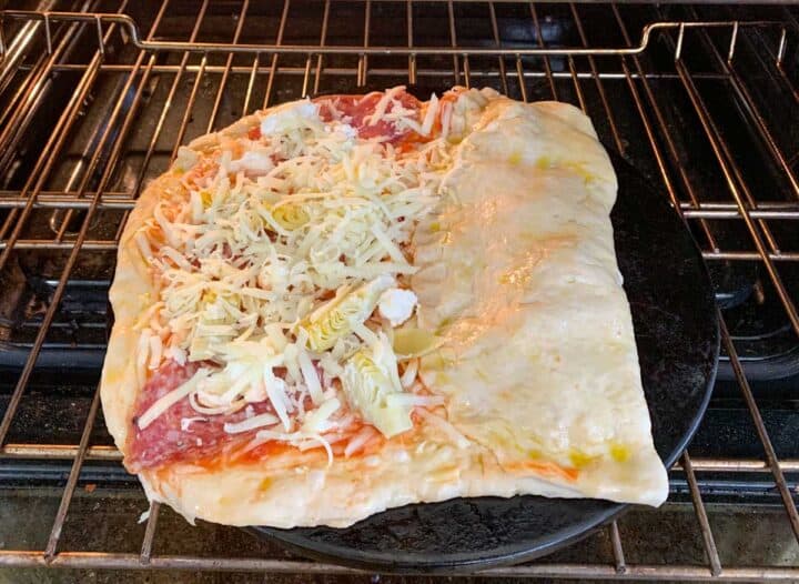 uncooked pizza in the oven