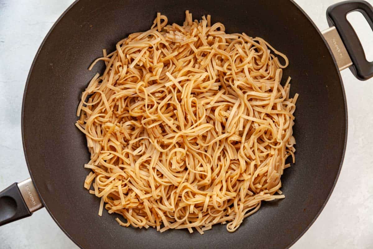 cooked brown rice noodles in a wok