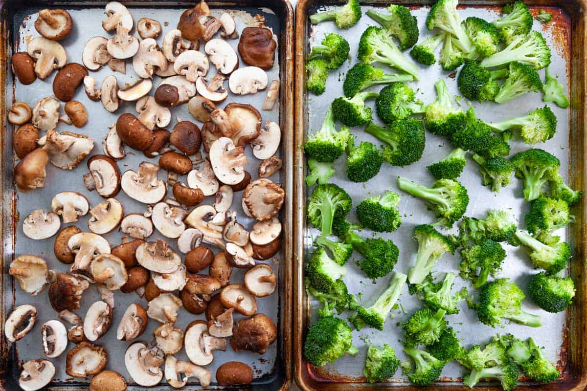 sheet-pans of raw mushrooms and broccoli florets