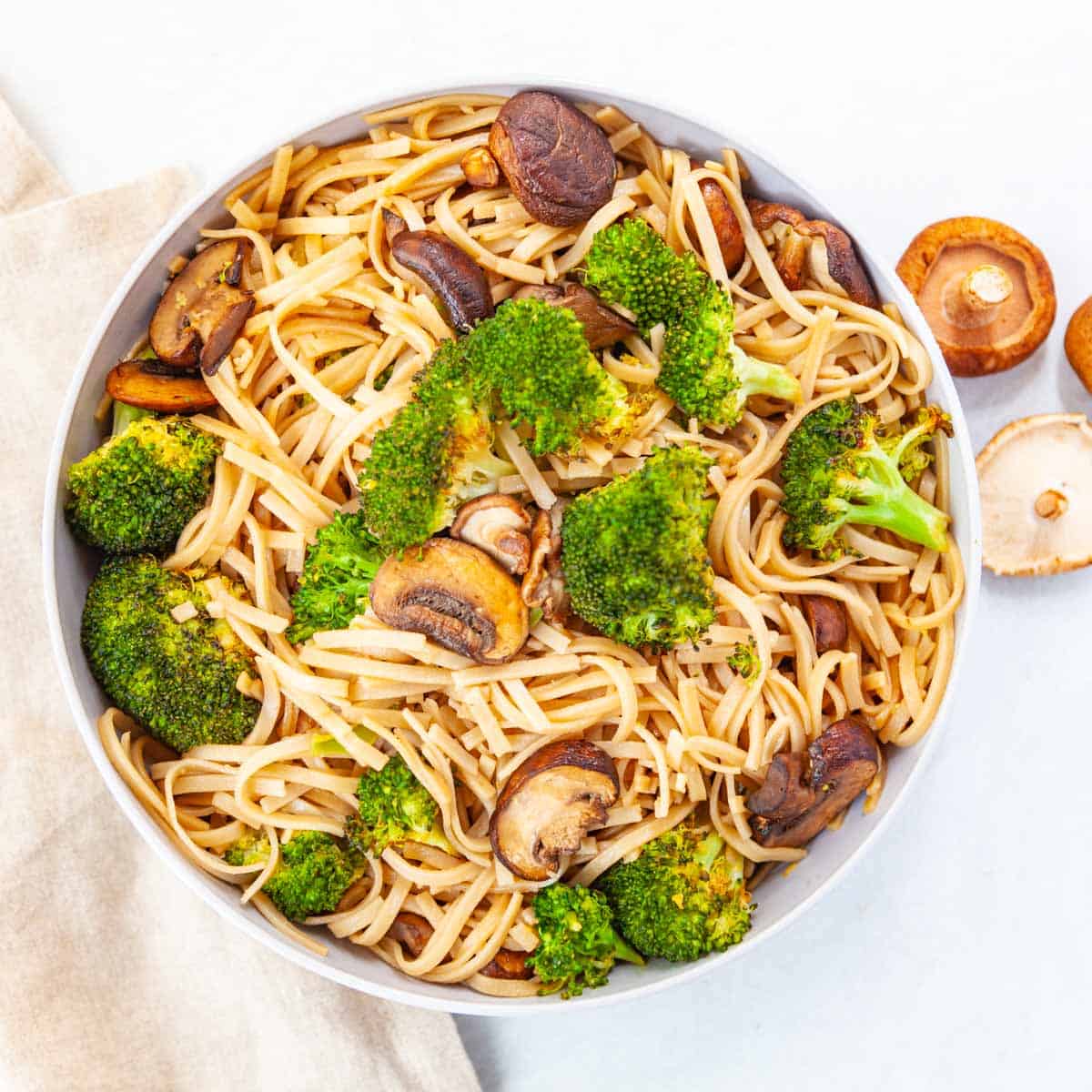 bowl of rice noodles, broccoli and mushrooms