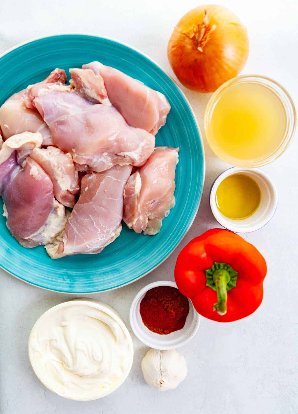 ingredients for chicken paprika: chicken thighs, creme fraiche, garlic, paprika, red bell pepper, olive oil, chicken broth, onion