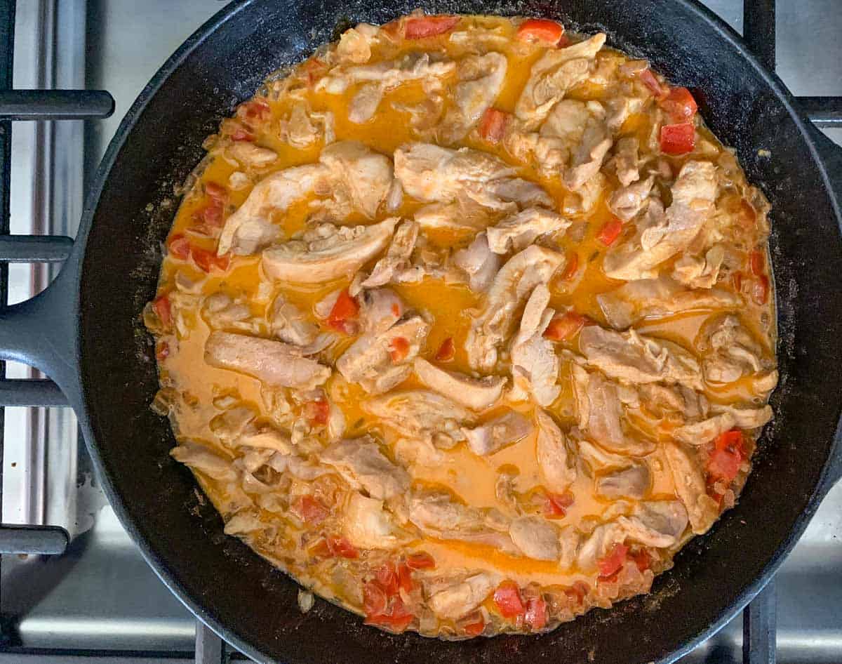 Return the sliced chicken to the skillet. Add salt if needed.