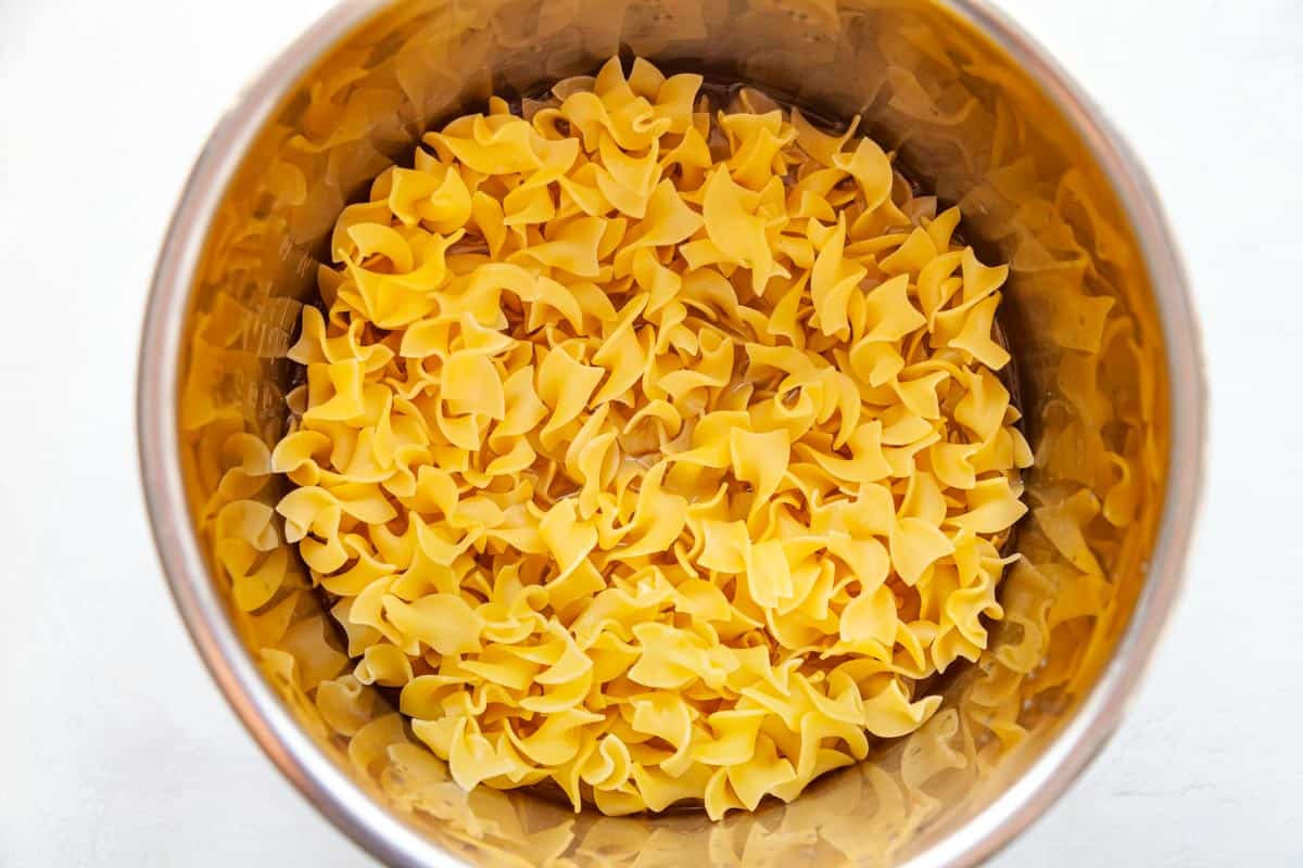 dried egg noodles in a pressure cooker pot