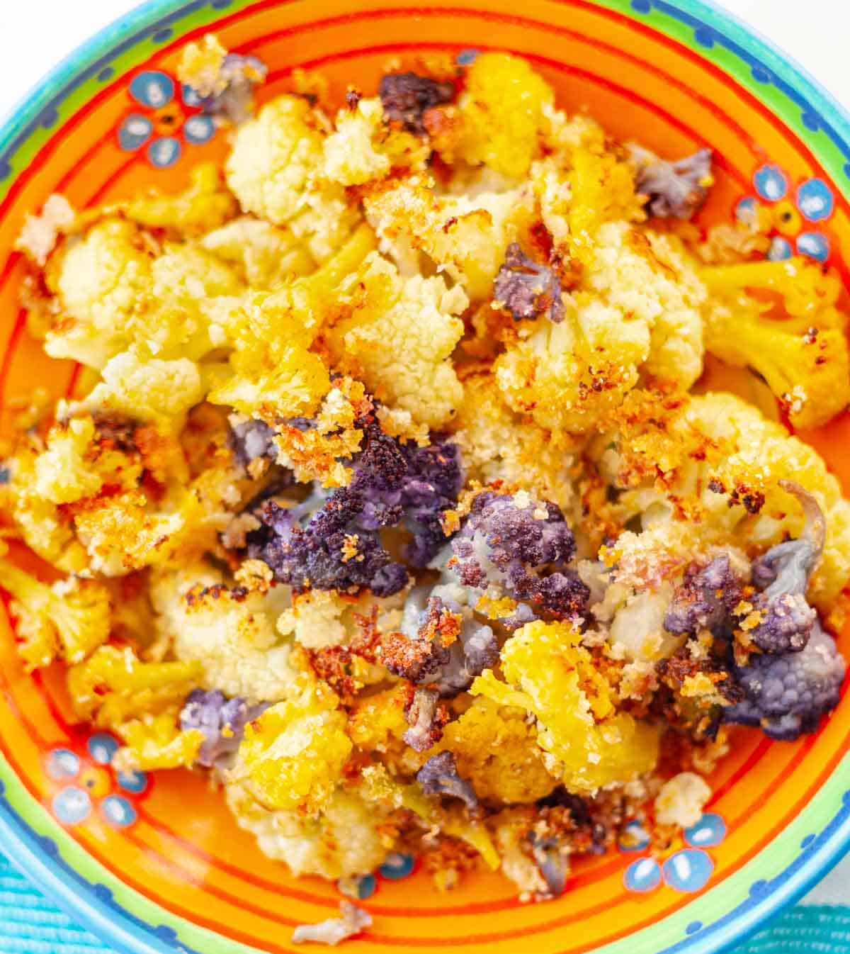 a bowl of roasted frozen rainbow cauliflower with breadcrumbs