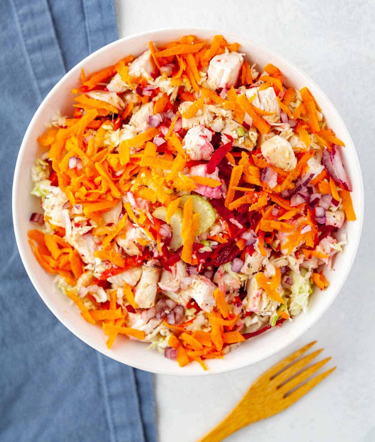 bowl of grated veggies and chopped chicken breast