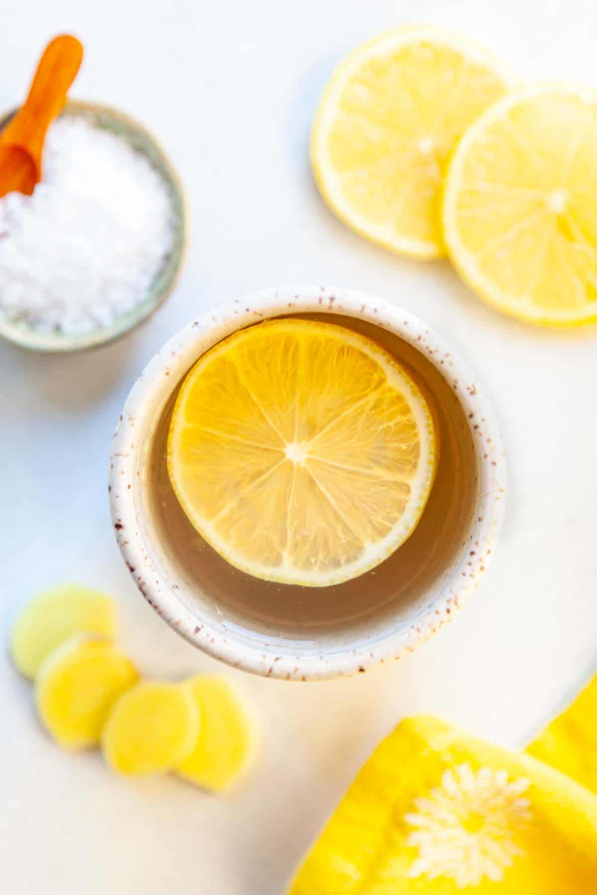 a mug of garlic ginger tea with a slice of lemon