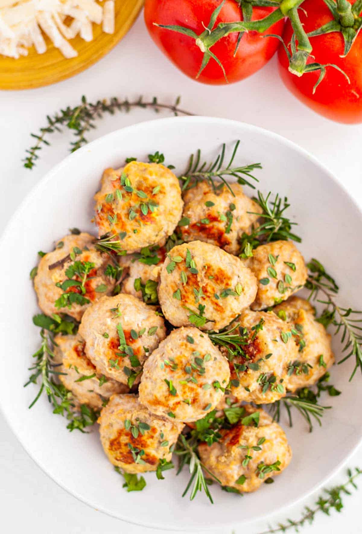 bowl of turkey ricotta meatballs with herbs on top