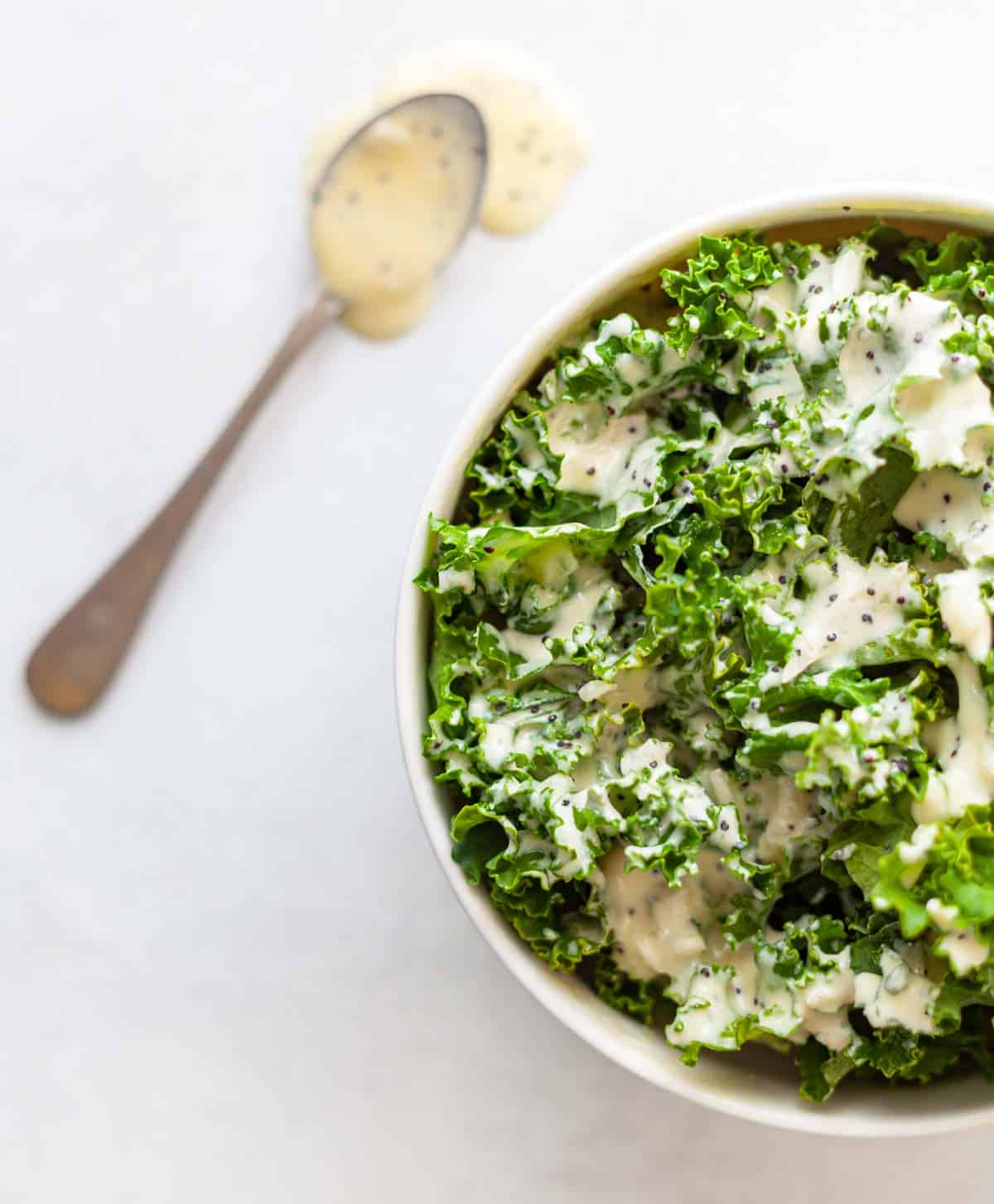 creamy poppyseed dressing on a kale salad