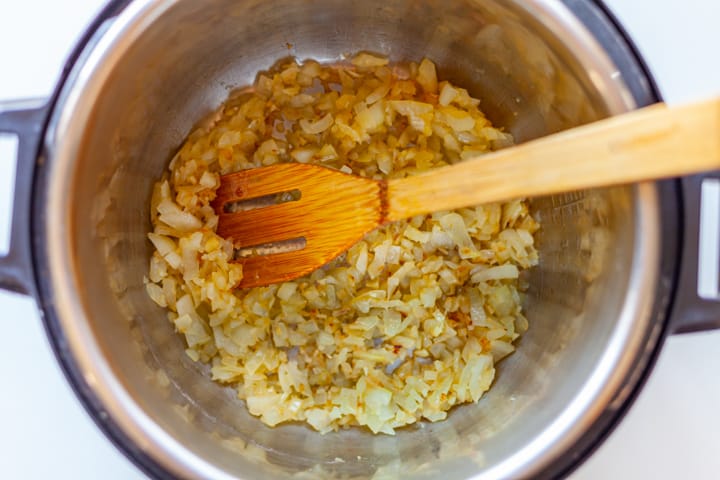 onion sauteing in a pressure cooker