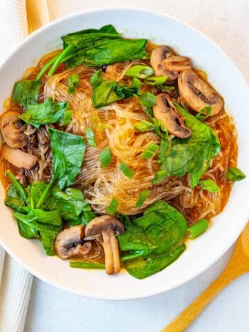bowl of glass noodle soup with mushrooms