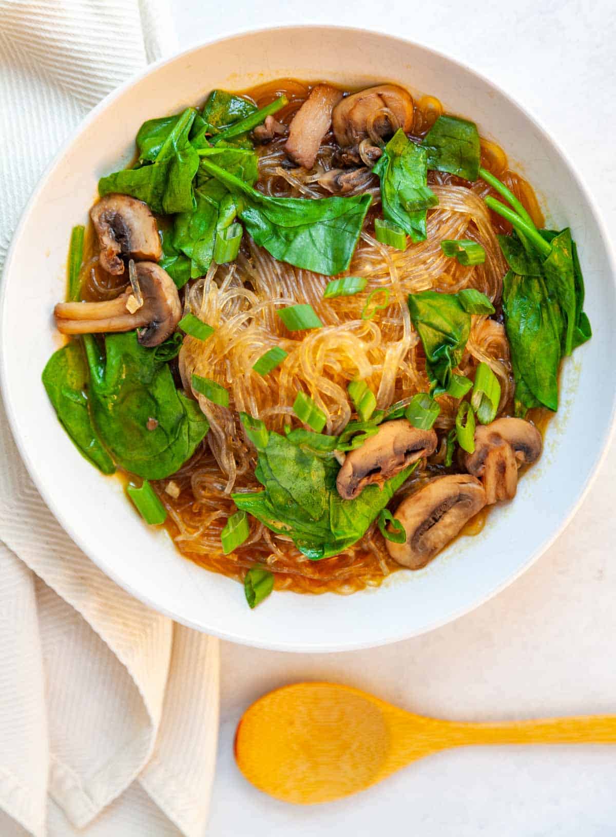 bowl of glass noodle soup with mushrooms