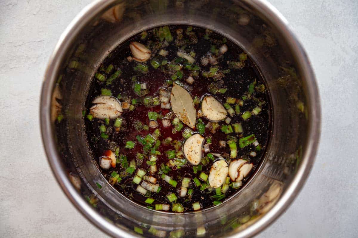 green onion, garlic, soy sauce and other ingredients in a pressure cooker