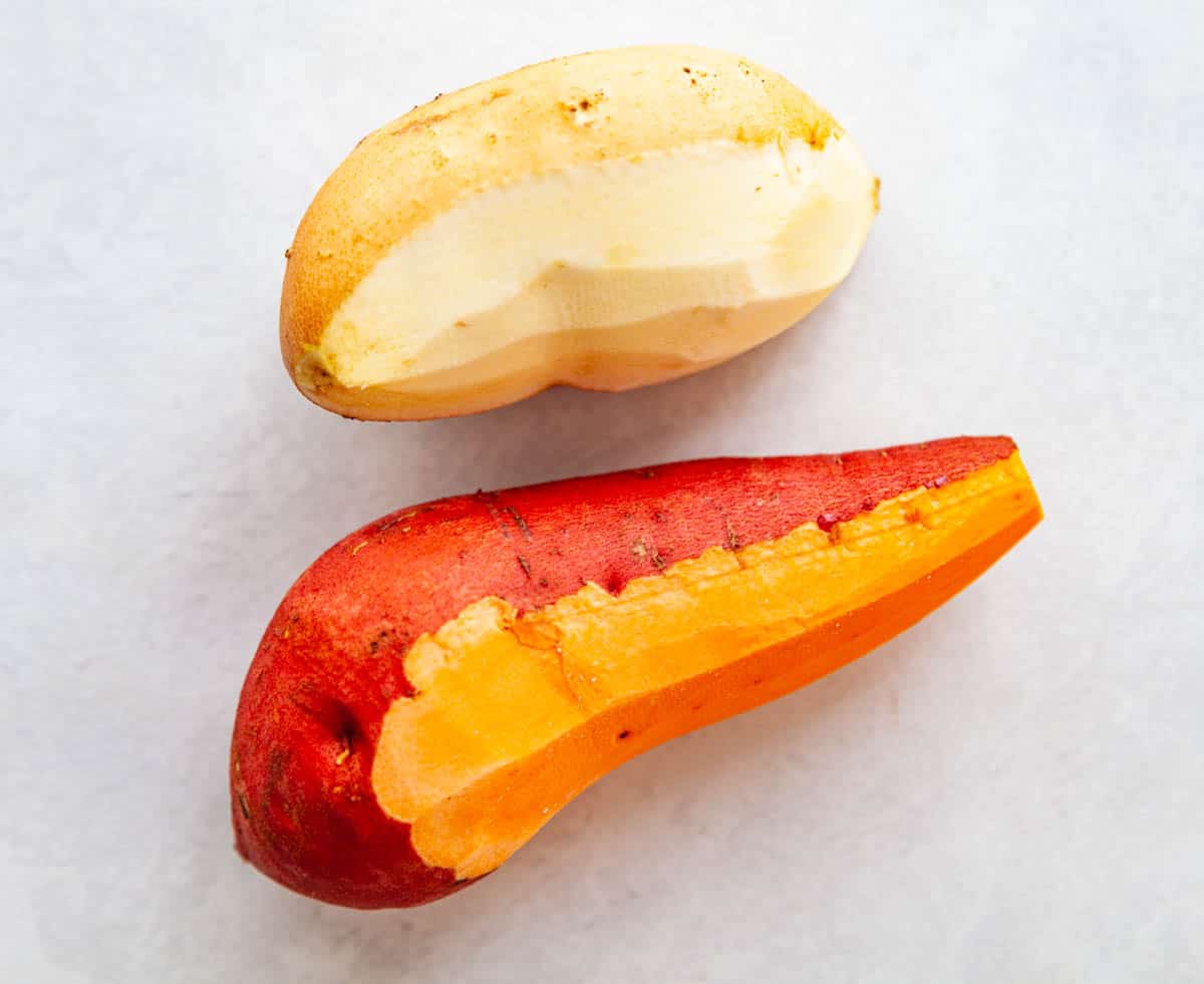 a white and an orange raw sweet potato