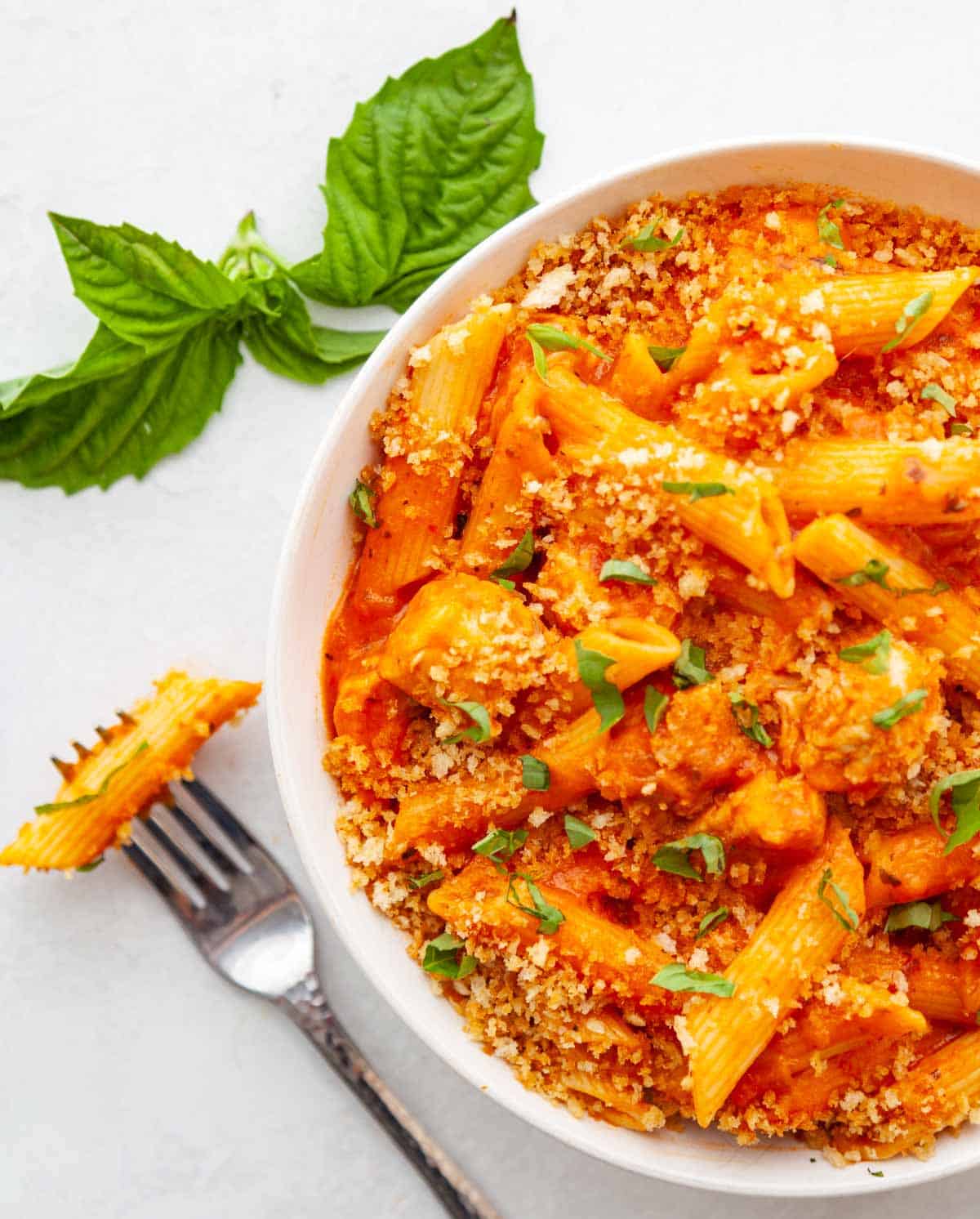 a bowl of instant pot chicken-penne pasta with marinara and cheese