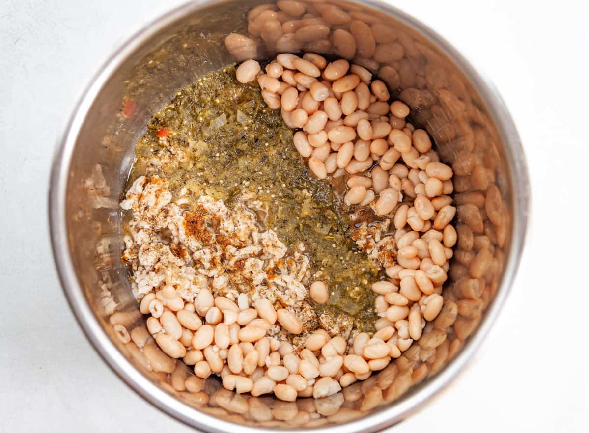 ground turkey, spices, canned white beans and tomatillo salsa in a pressure cooker