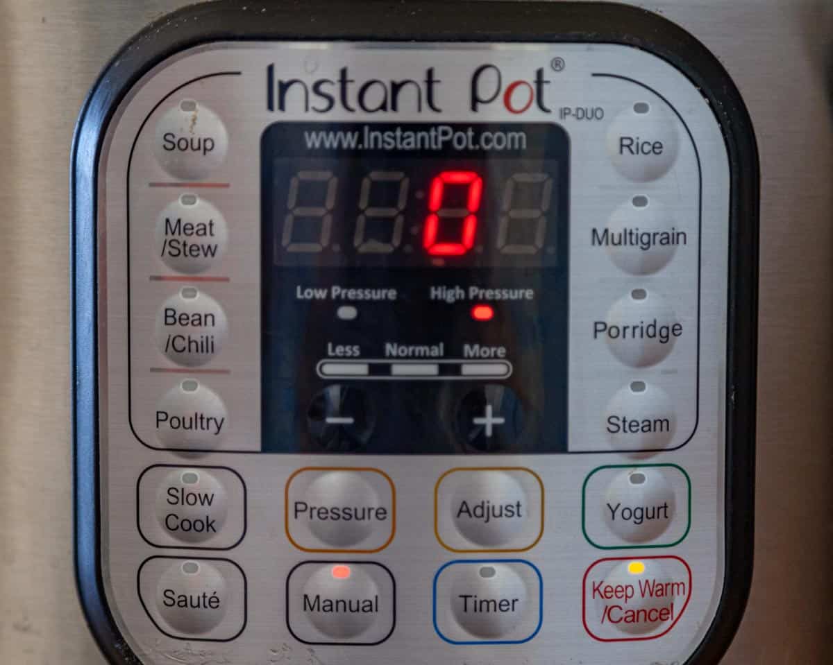 photo of Instant Pot setting buttons and the digital timer cooking on manual for zero minutes