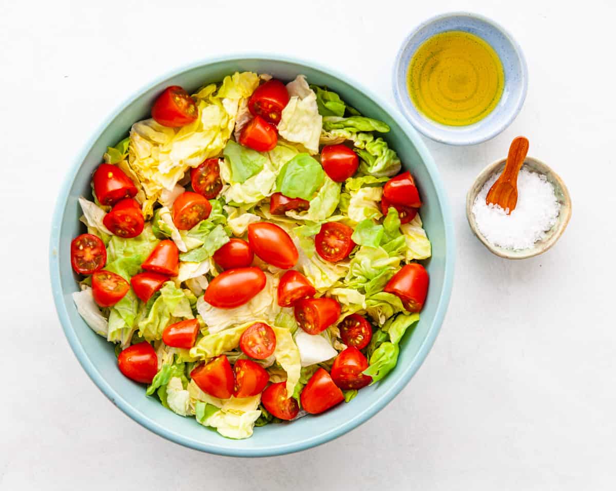 a bowl of butter lettuce and cherry tomatoes