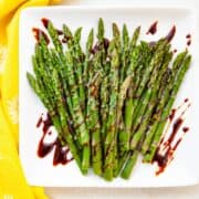 a plate of asparagus drizzled in balsamic glaze
