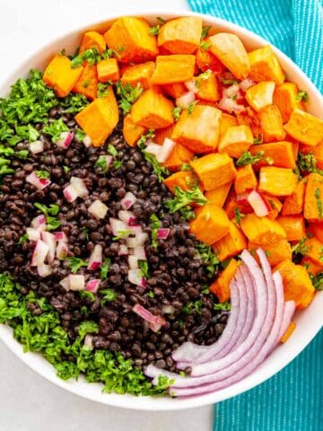 bowl of beluga black lentil salad with sweet potatoes & maple dijon dressing