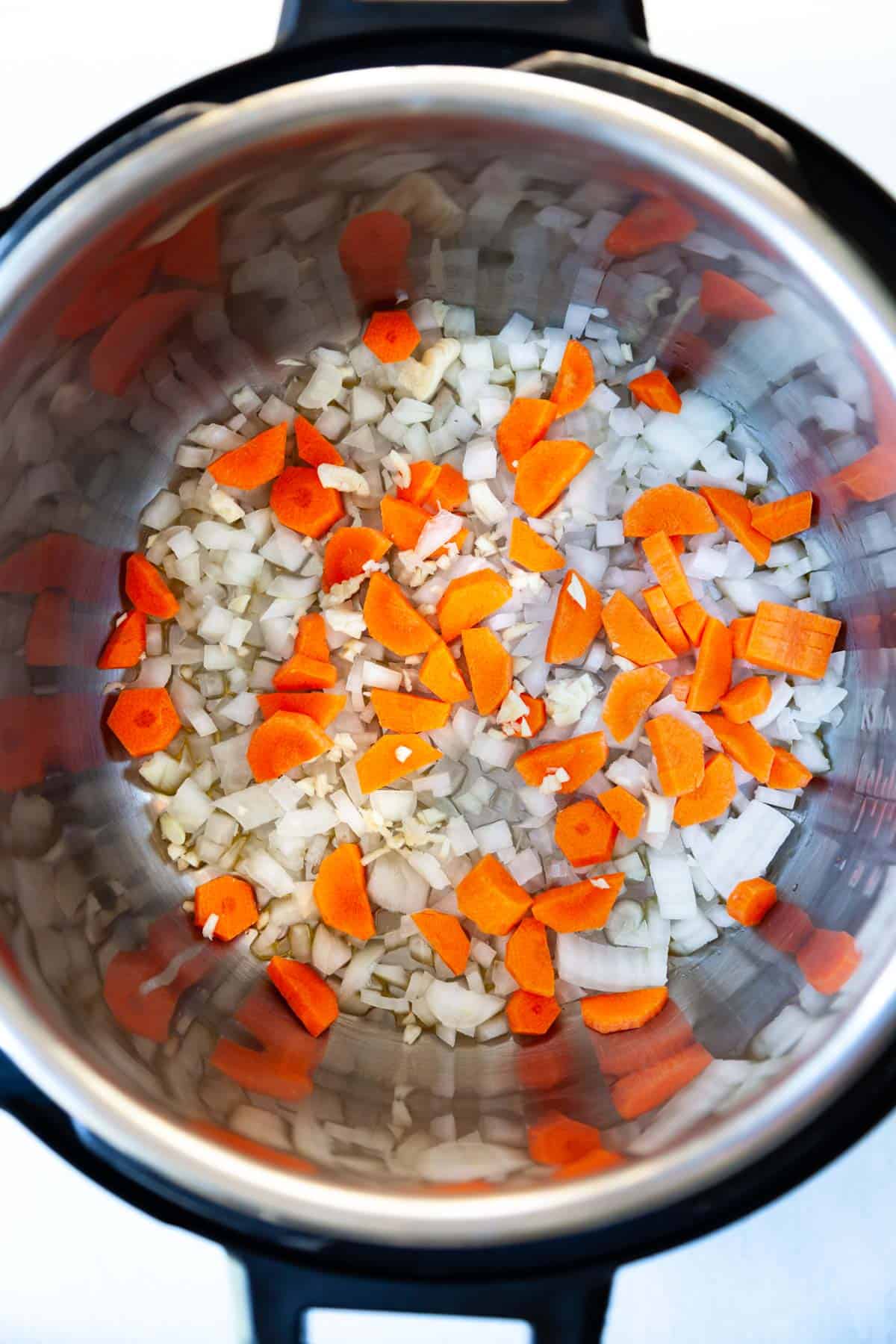 chopped onion and carrot in an Instant Pot