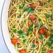 close-up of cooked spaghetti with frozen kale and cherry tomatoes
