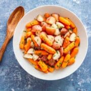 a bowl of cooked baby potatoes and baby carrots