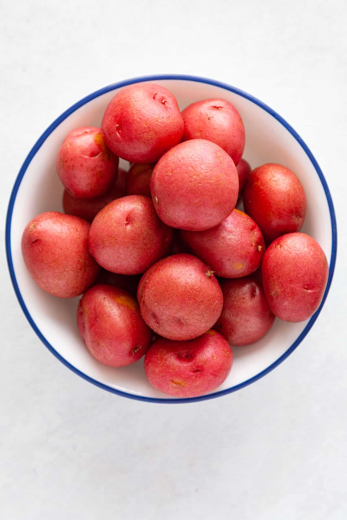 a bowl of raw, small red potatoes